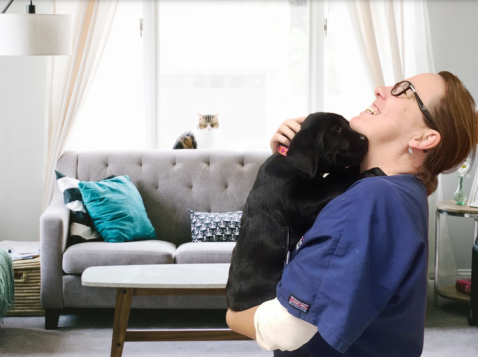 Dr. Karen Pooler with a dog and cat in the comfort of their home
