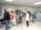 men and women conversing in an art gallery