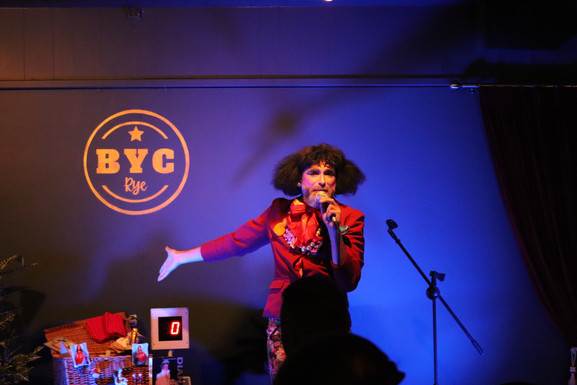 The drag act, Timberlina, presenting Bingo on stage.