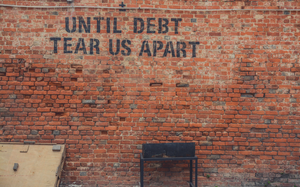 Brick wall with debt grafitti