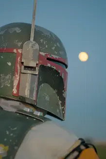 portrait photo of a man dressed up as bobba fett from star wars - looking towards the moon