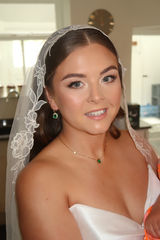 Bride wearing soft glam bridal makeup with glowing skin and nude lips