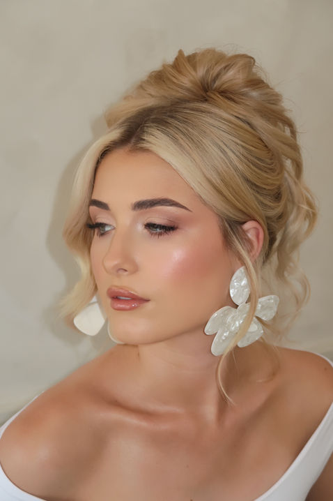 Bride wearing soft glam bridal makeup with glowing skin and nude lips