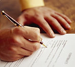 Somene Signing a Document