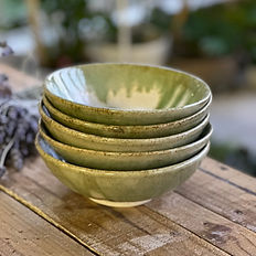 stack of green ceramic bowls