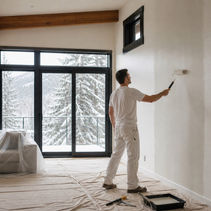 Painter completing an interior repaint in a protected Whistler home during winter.