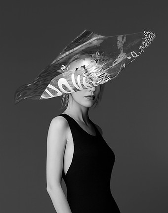 Black and white ai futuristic hat, full of colors and shapes, sharp shapes, crazy hat, editorial photography