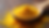 Close-up view of bee pollen granules in a wooden spoon