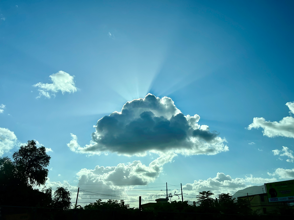 A picture of the sky with a cloud blocking out the sun