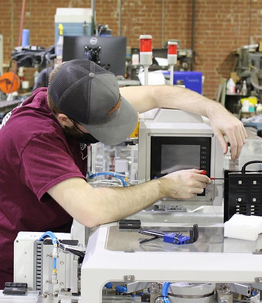 Tech Servicing Industrial Equipment at the Automated Manufacturing facility
