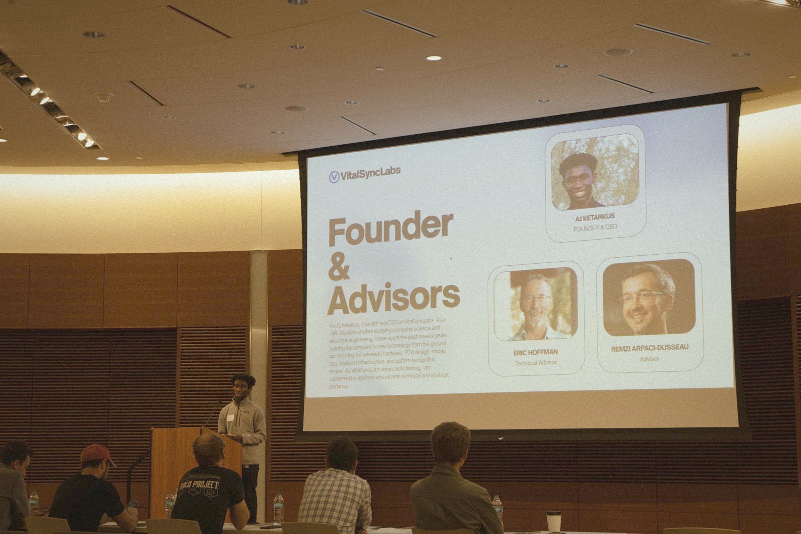 AJ Ketarkus pitching VitalSyncLabs at the podium