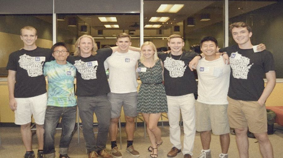 A row of early Transcend members in matching shirts, arms around each other