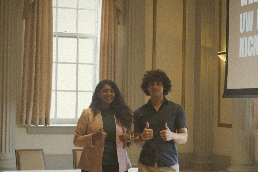 Two students giving thumbs up at the kickoff