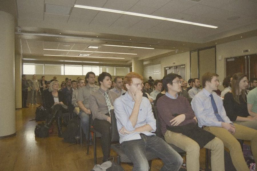 A packed room of students listening to a talk