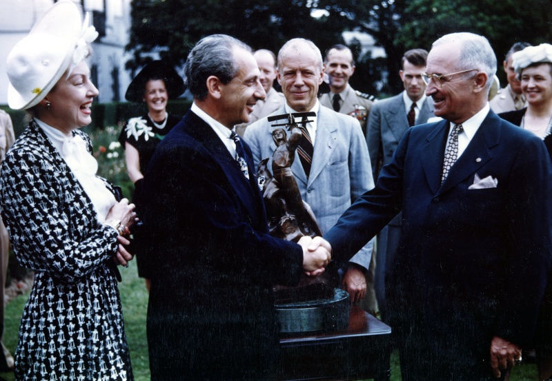 In ceremonies on the White House lawn, President Harry S. Truman awarded the International Harmon Trophy to Major Alexander P. De Seversky, aeronautical engineer. The Ligue Internationale des Aviateurs awarded the trophy to De Seversky for "outstanding leadership, patriotism, and unselfish devotion to the security and aeronautical progress of the United States." From left to right: Mrs. Evelyn De Seversky, Major Alexander De Seversky, Secretary of War Robert Patterson, and President Harry S. Truman, June 24, 1947, Harry S. Truman Library & Museum