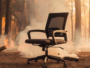 An office chair sitting in a burning forest.