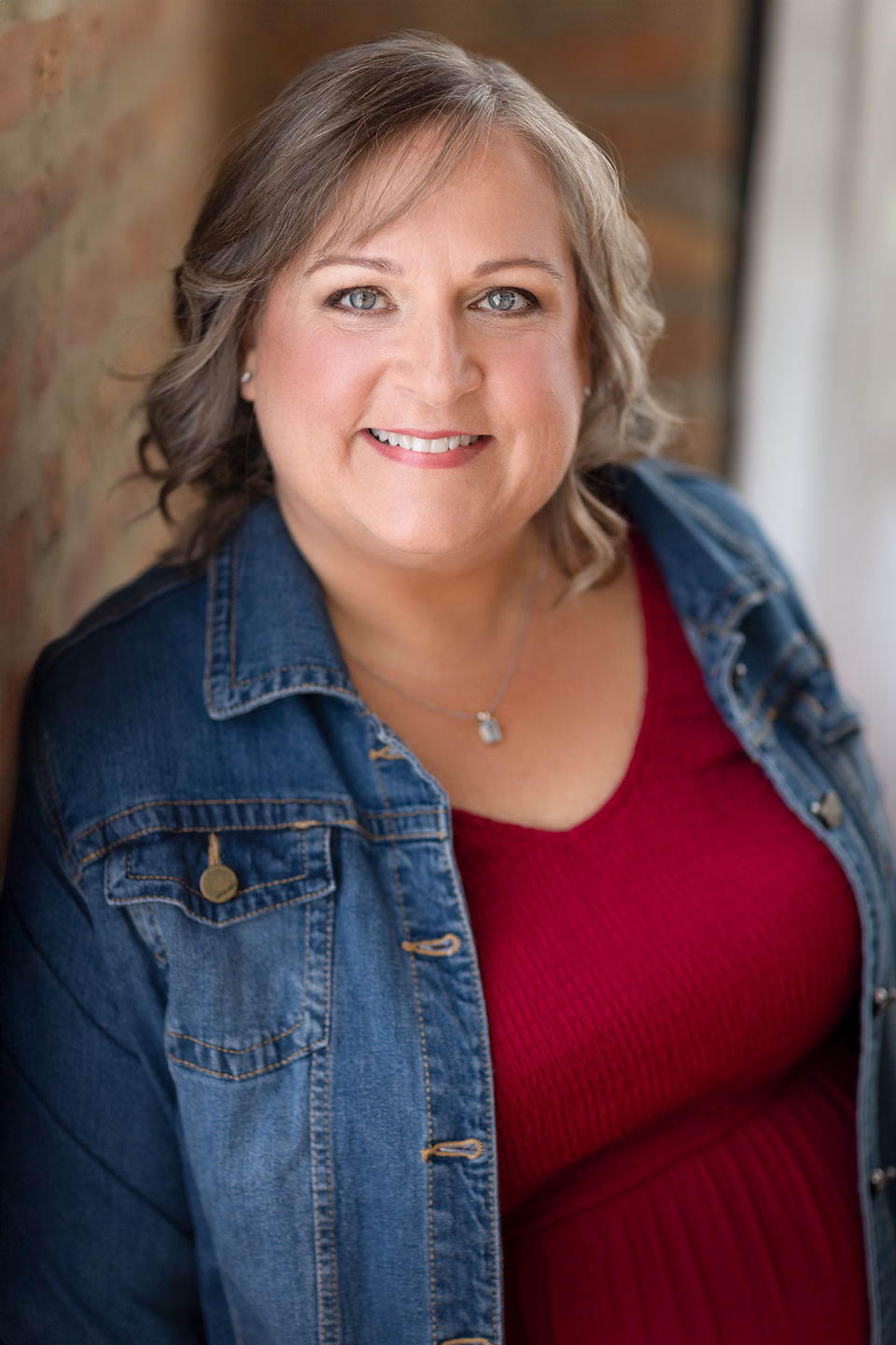 Example of a casual professional photo, woman in natural light beside window, closeup