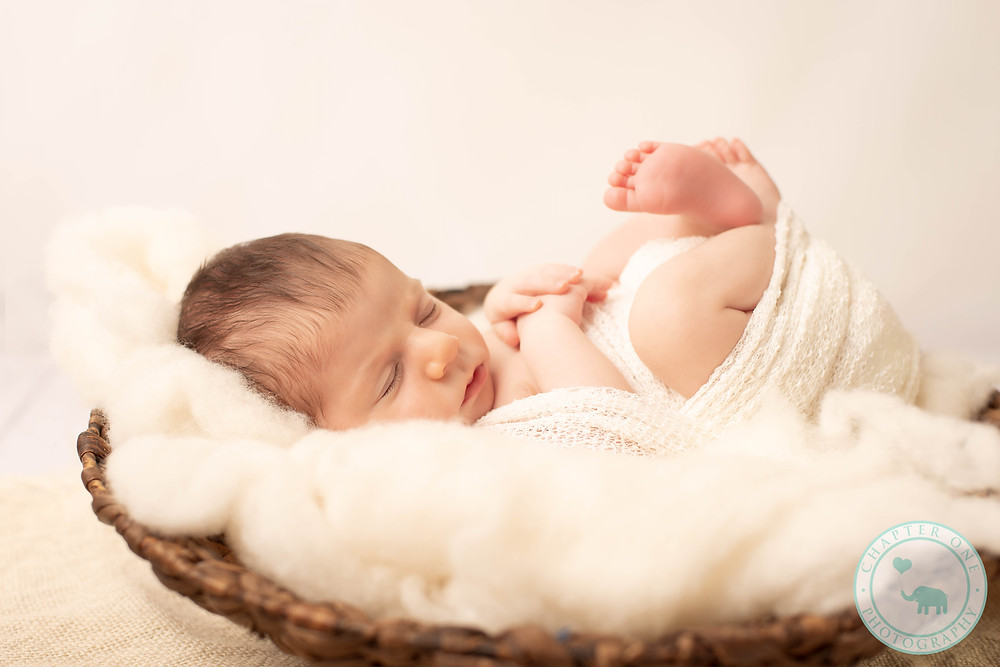 Newborn girl asleep in basket
