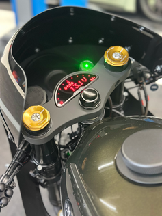 Close-up of BMW R100 cockpit with inverted GSXR forks and custom gauge cluster.