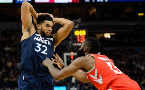Minnesota Timberwolves basketball player Karl-Anthony Towns is playing basketball against Houston Rocket James Harden.