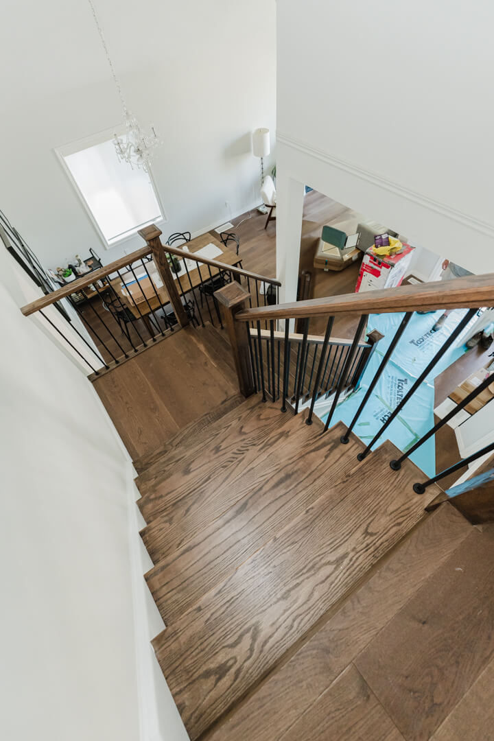 Custom oak hardwood staircase in Elora with Minwax Jacobean stain and clear coat by Luma Build Design