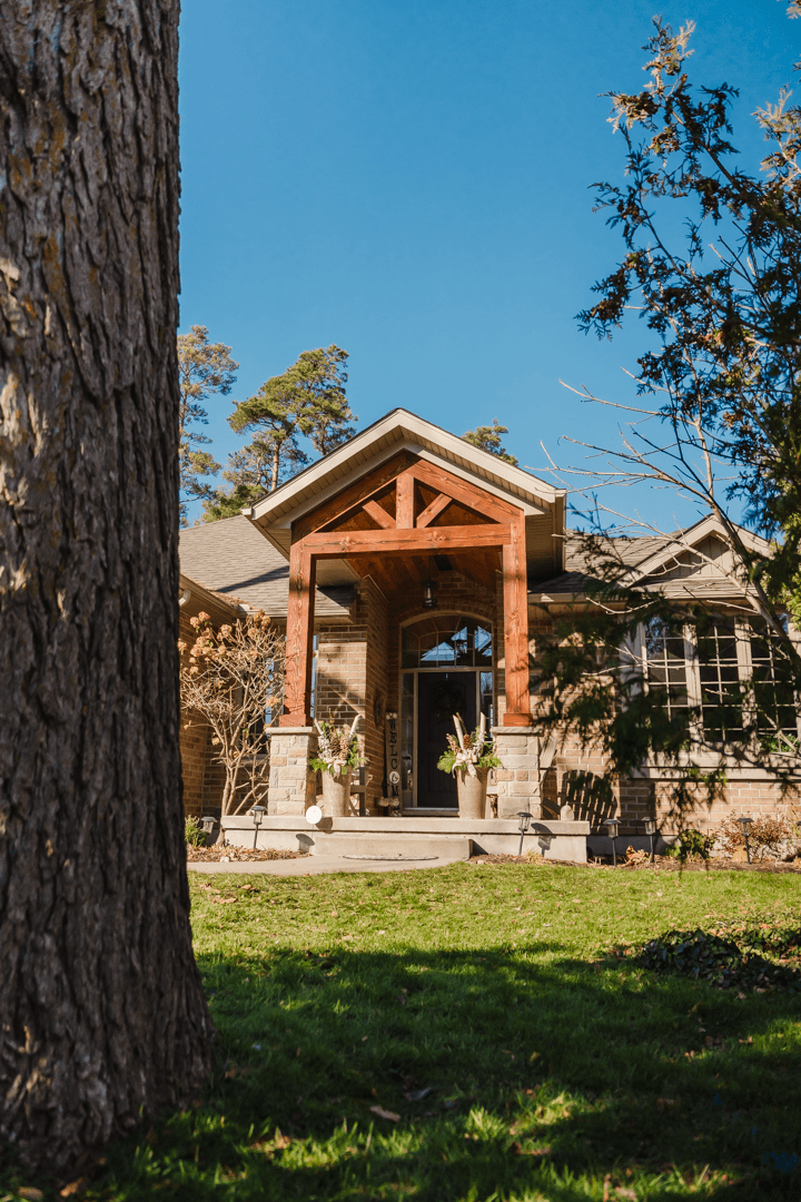 Timber frame great room addition with exposed Douglas fir beams and stone fireplace Ontari