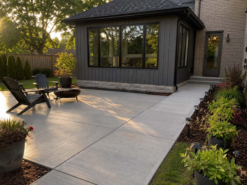 Finished concrete patio and walkway connecting to a home addition in Fergus