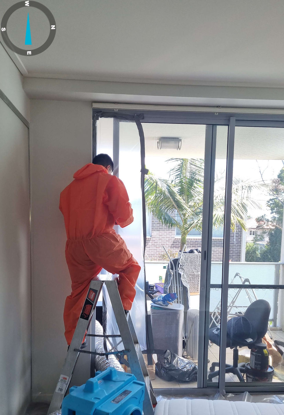 image shows a technician setting yp the drying chamber getting ready for dehumidifiers and fans to dry the units