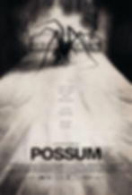 A monochrome movie poster with spider legs coming out from a bag placed on a bed