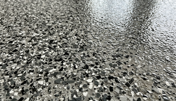 Close-up view of decorative flakes embedded in a garage floor coating