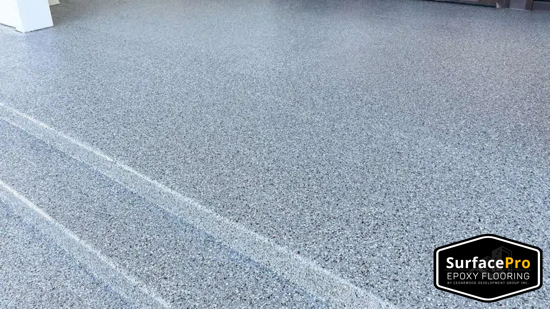 Decorative epoxy flake floor in a GTA garage with colorful vinyl chips embedded in the resin coating.