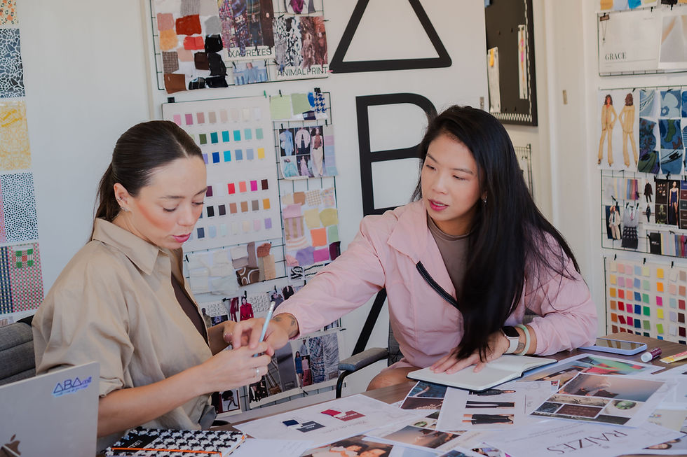 Two people comparing fabric swatches and garment options for work polos and uniforms