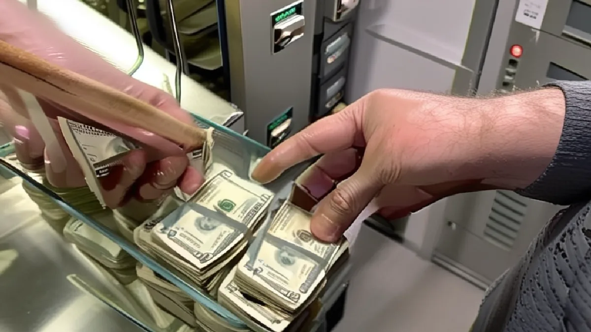Workers secure cash containers in a dispensary back room, showing the operational burden of cash-heavy cannabis businesses.