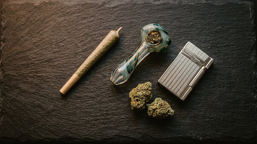 Top-down flat-lay of solo cannabis session accessories including a pre-roll, pipe, lighter and cannabis nugs