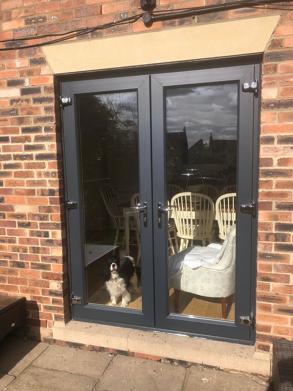 Stylish grey French doors installation in Middlesbrough, offering a modern finish with secure double glazing to enhance natural light and garden access.