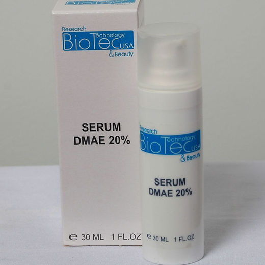 White bottle labeled "Serum DMAE 20%" next to matching box on a white surface. Blue and black text. Simple, clinical packaging.