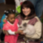 Little girl petting furry bunny