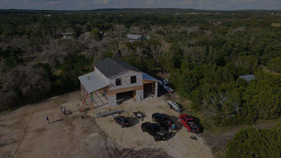 A roof installation on a home surrounded by Central Texas trees