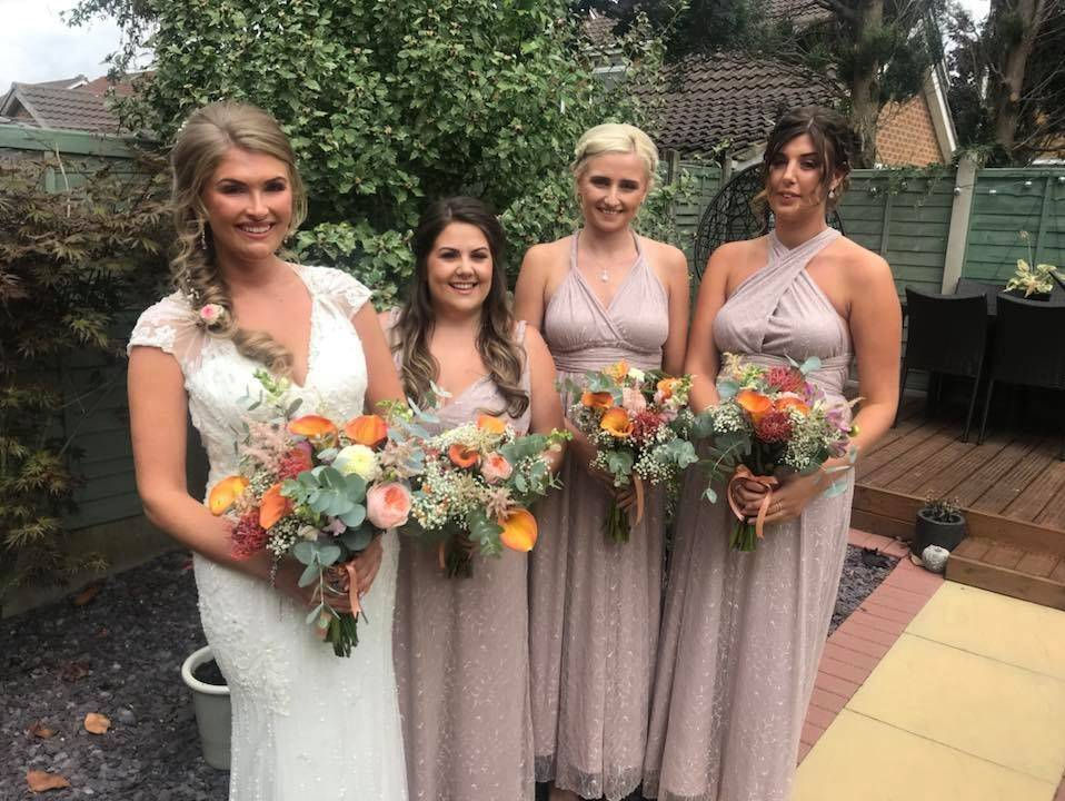 Burnt orange calla lily and Juliette David Austin roses with greenery and blush pink