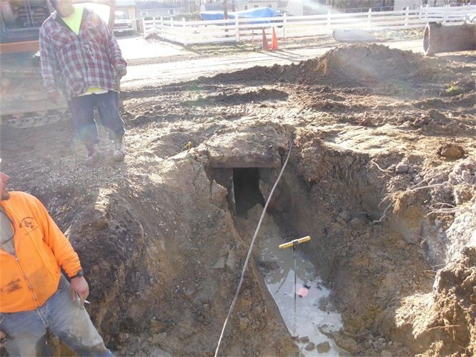 Uncovering buried manhole