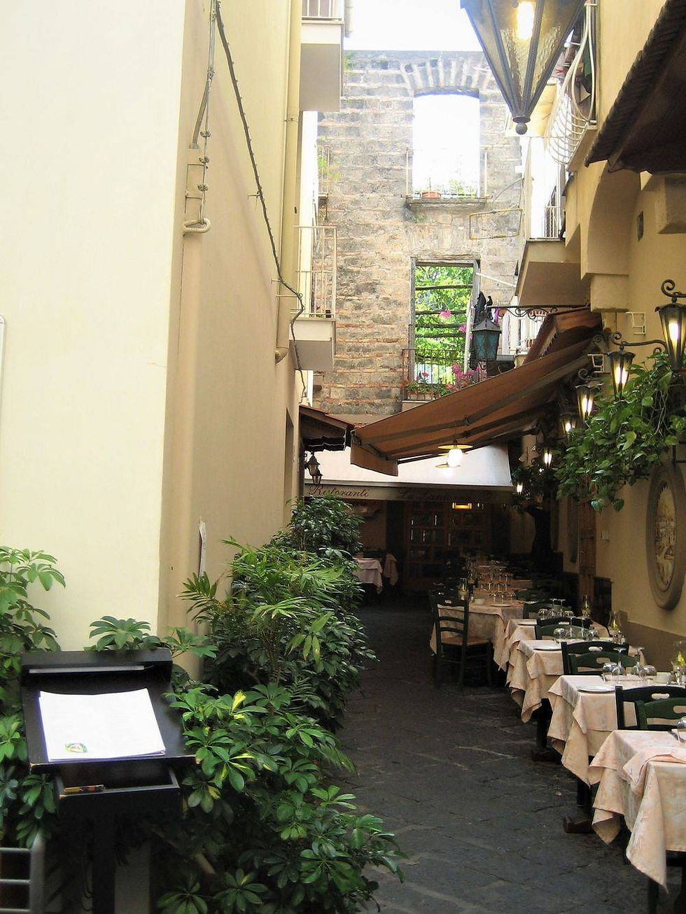 Positano, Sorrento, Amalfi, Amalfi Coast, Italy, history, Europe, European, buildings, homes, streets, history, Catholic, Christian, church, religion, faith, statues, markets, shops, stores, piazza, bars, restaurants, trees, shrubs, walls, plants, flowers, people, touring, tourists, hills, hillside, beaches, ocean, view, streets, roadways, columns, arches, steps, towers, domes, windows, fountains, photography, pictures, city, boats, docks, marina, patio seating, dinner, meals, lanterns, restaurant