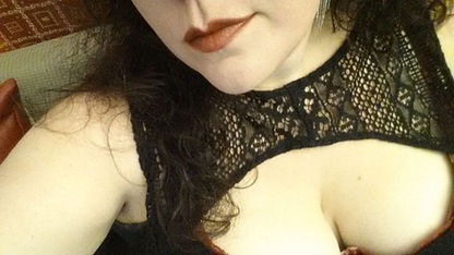 caucasian woman red lips large breasts black peekaboo top