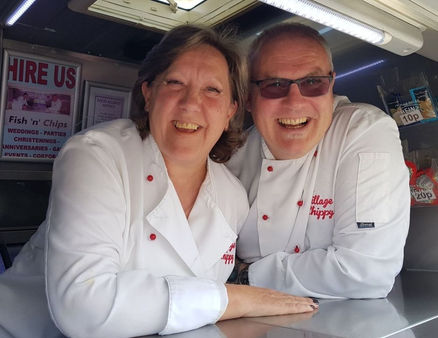 Owners Amanda and Garry inside the fish and chip catering van laughing their heads off after a very busy and long night. They look shattered.