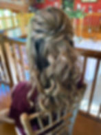 A picture of a lady wearing her hair in a half up half down by GirlyGlam