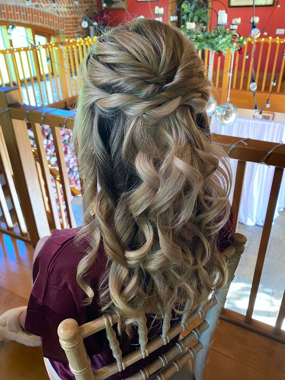 A picture of a lady wearing her hair in a half up half down by GirlyGlam
