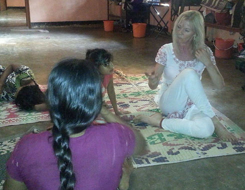 Yoga Instructor Rebecca Bachar teaching India Orphans Seated Spinal Twist