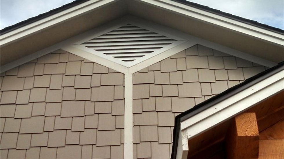 Close-up view of a decorative wooden gable vent with intricate lattice design
