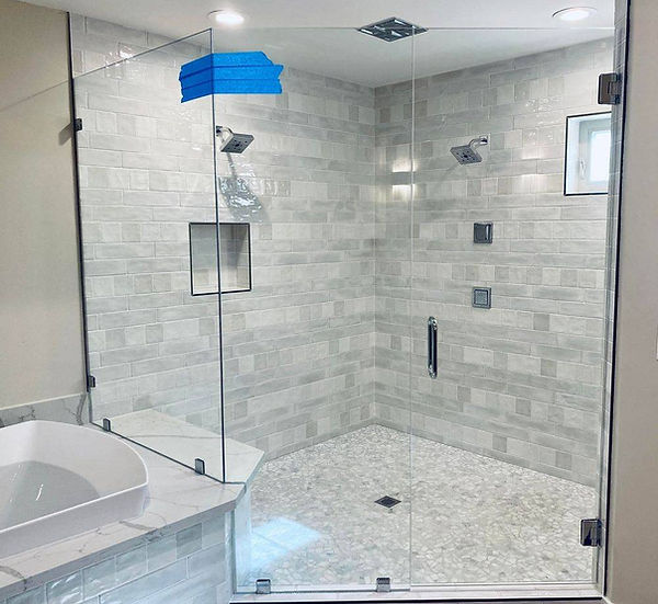 Frameless glass shower enclosure with modern tile