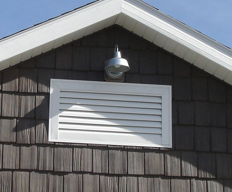Close-up view of a rectangular gable vent installed on a house gable