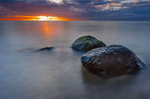 misty sunset with rocks